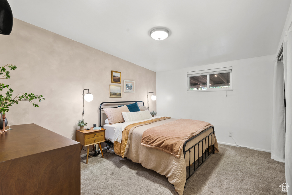 Bedroom featuring carpet flooring and baseboards
