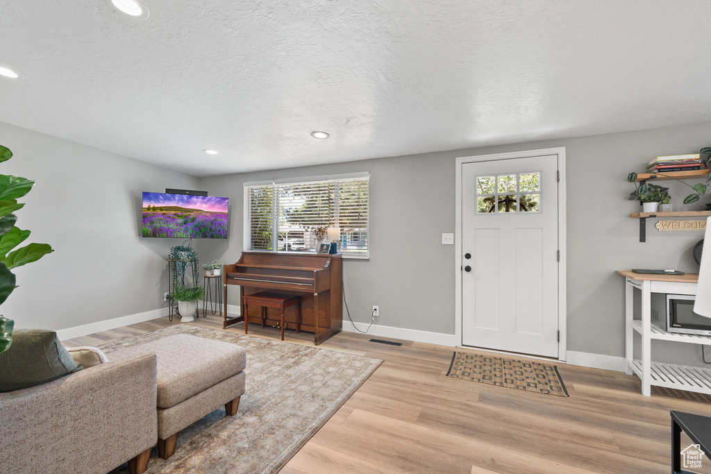 Foyer featuring wood finished floors, recessed lighting, and a textured ceiling