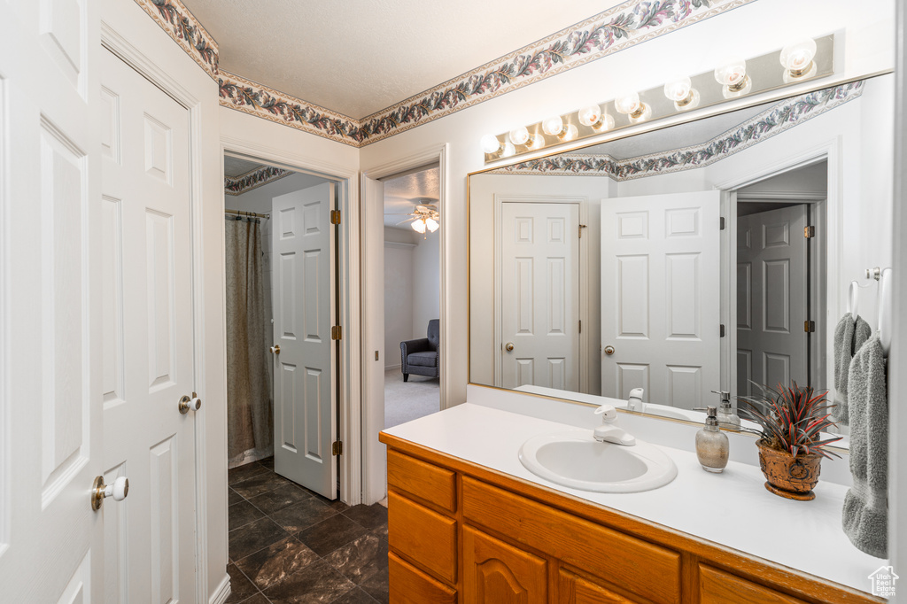 Full bathroom featuring vanity and curtained shower