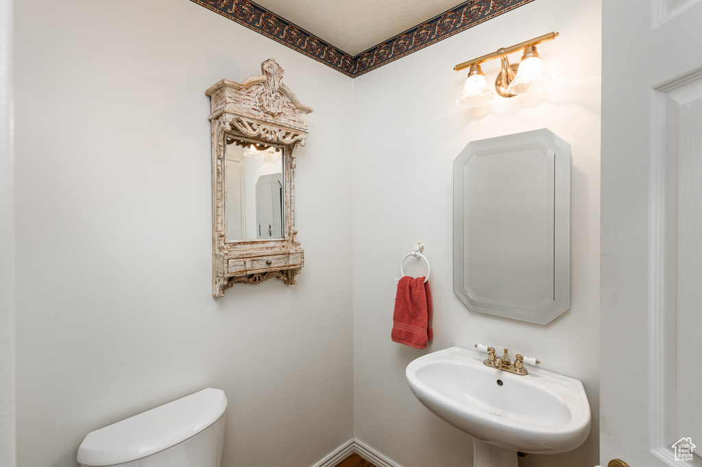 Half bathroom with toilet and a sink
