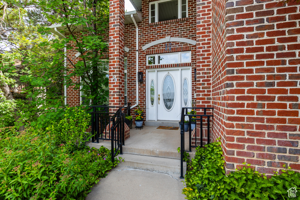 Property entrance featuring brick siding