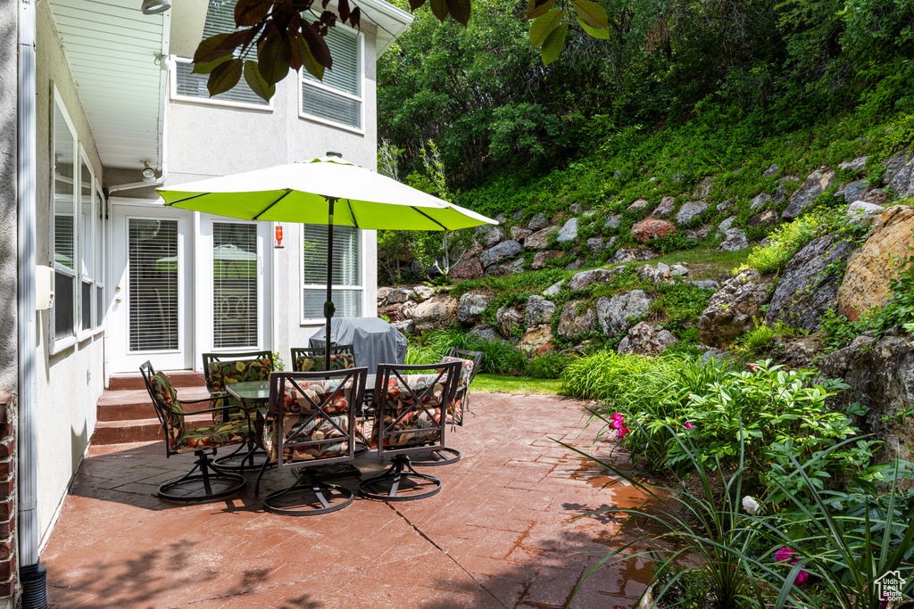 View of patio with outdoor dining space and area for grilling