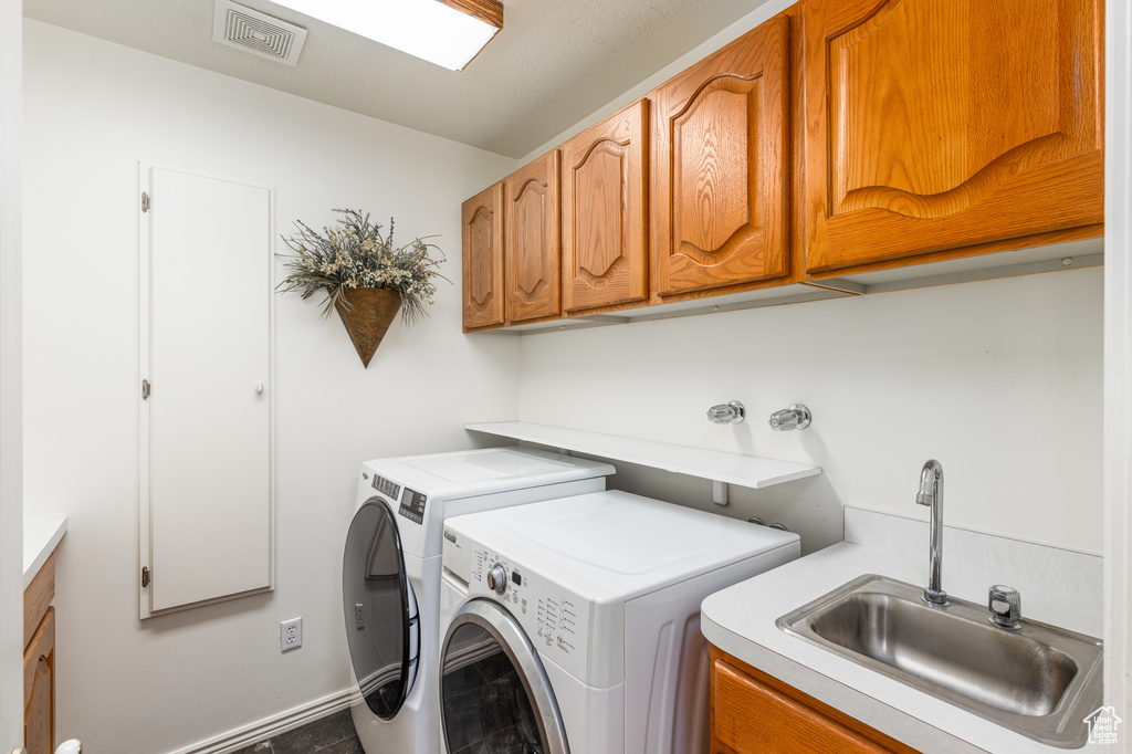 Washroom with separate washer and dryer and cabinet space
