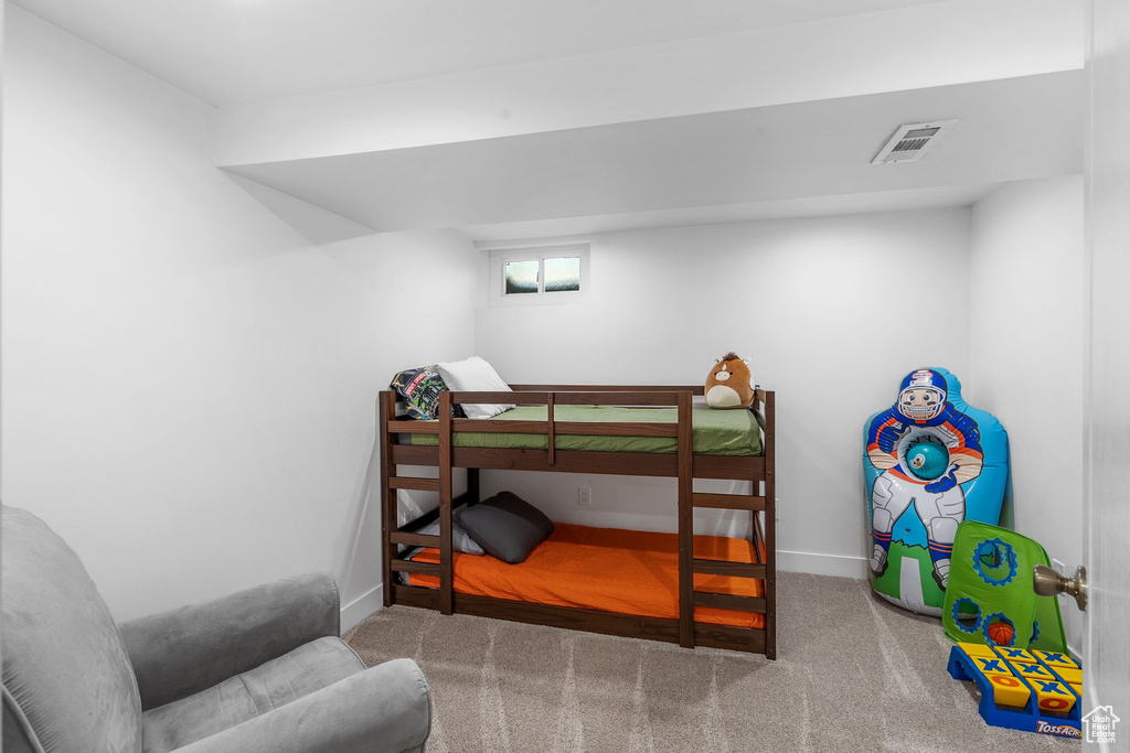 Bedroom with carpet flooring and baseboards