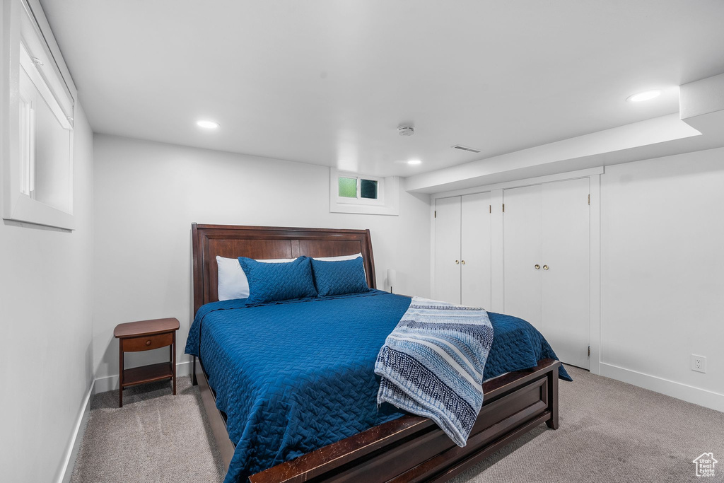 Carpeted bedroom featuring recessed lighting and a closet