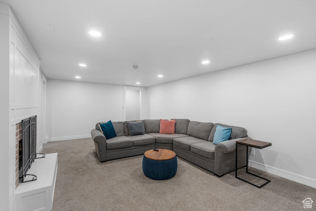 Living room with recessed lighting, carpet, and a fireplace