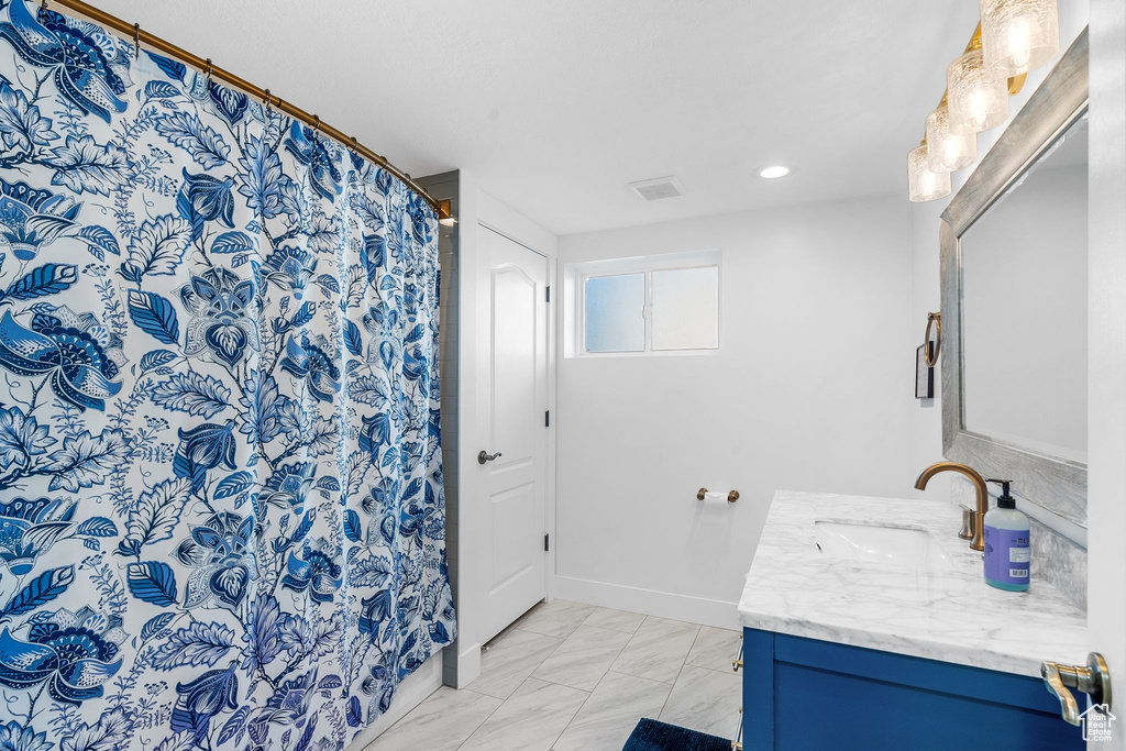 Full bath with vanity, marble look tile flooring, recessed lighting, and a shower with shower curtain