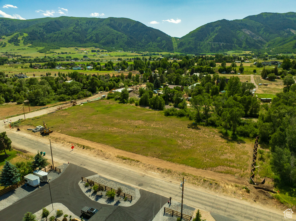 Overview of rural landscape featuring a mountain backdrop