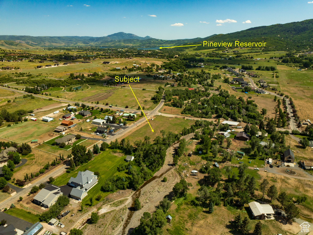 Aerial view of property\'s location featuring a mountain backdrop and rural landscape