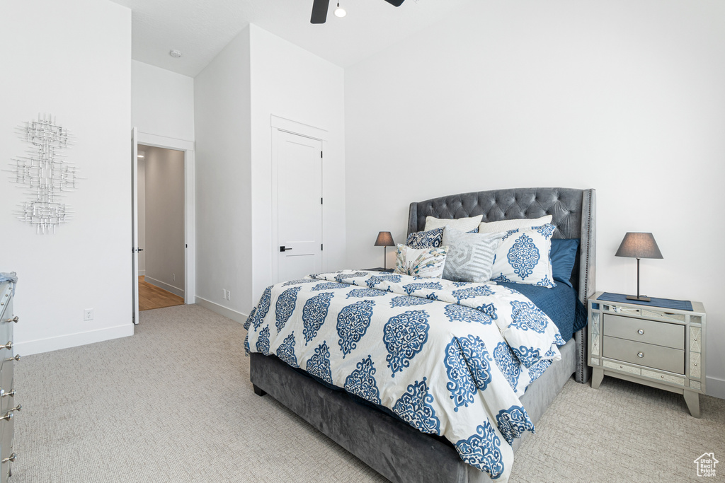Carpeted bedroom with baseboards and ceiling fan