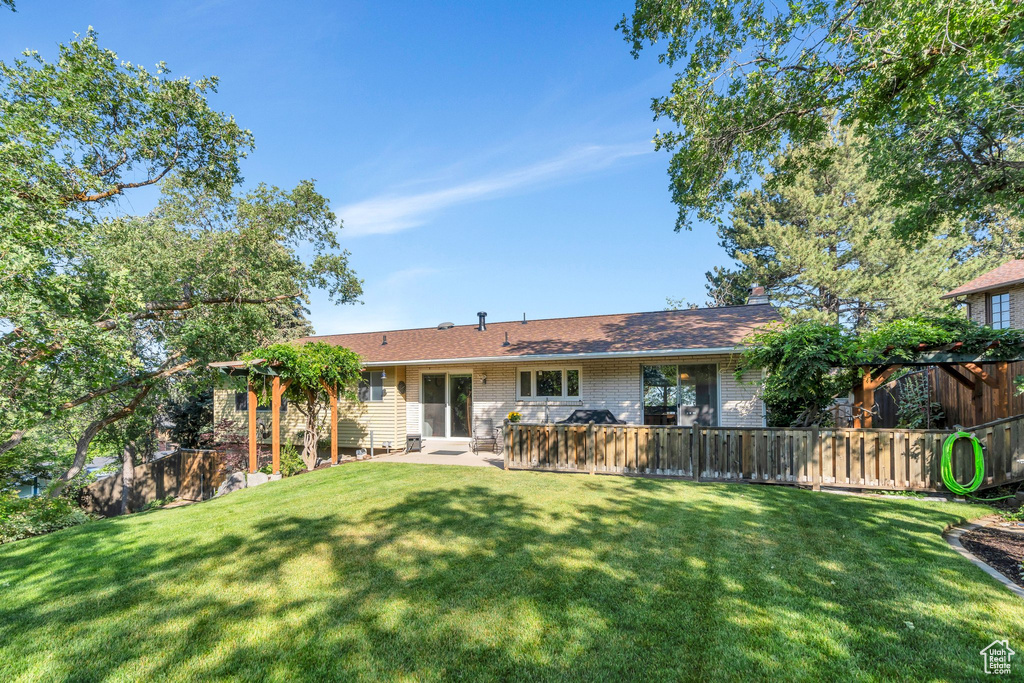 Rear view of property featuring brick siding