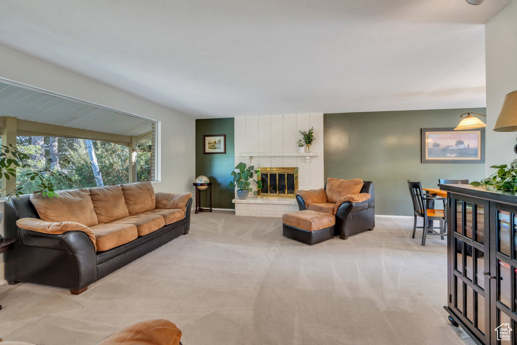 Living area featuring light carpet and a brick fireplace