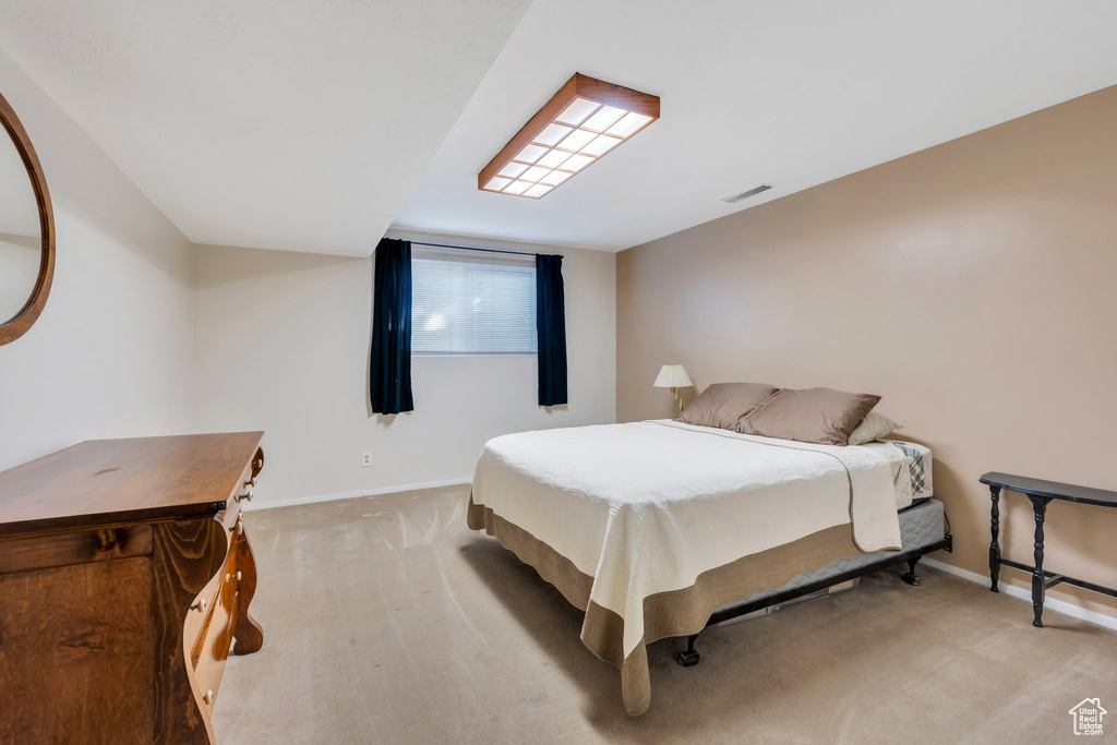 Bedroom with light carpet and baseboards
