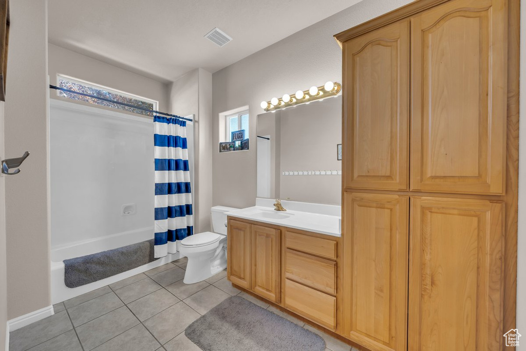 Full bathroom featuring vanity, tile patterned flooring, and shower / bath combination with curtain