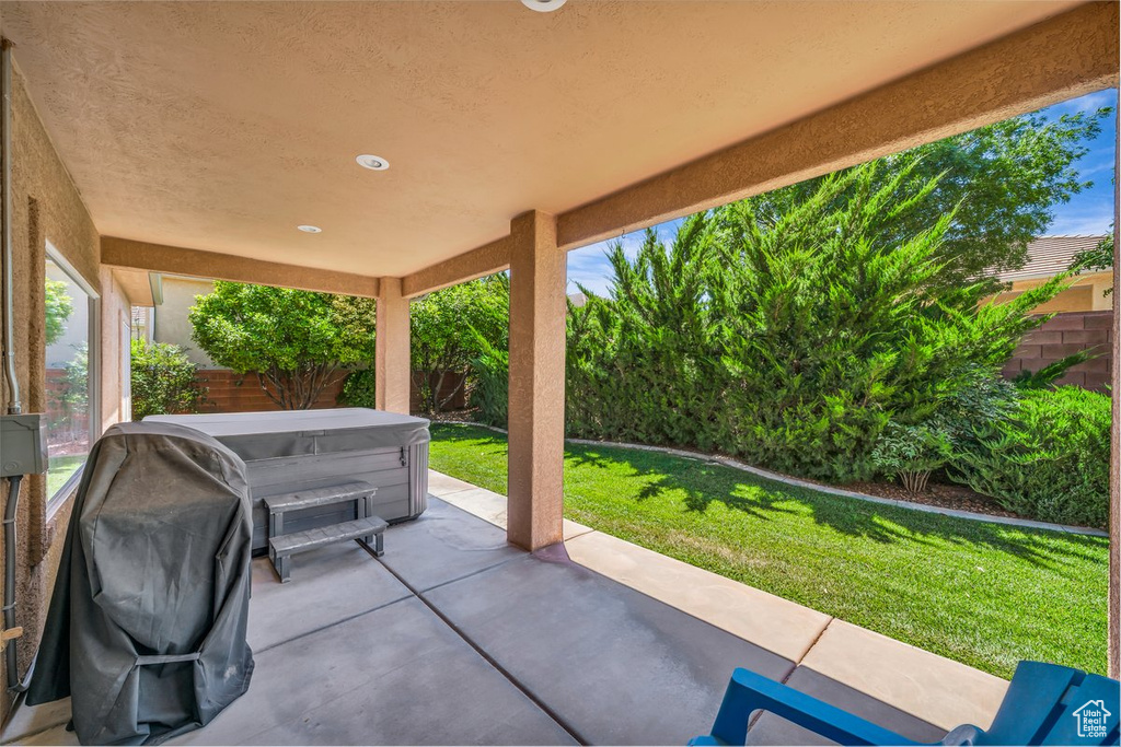 Fenced backyard featuring a patio and grilling area