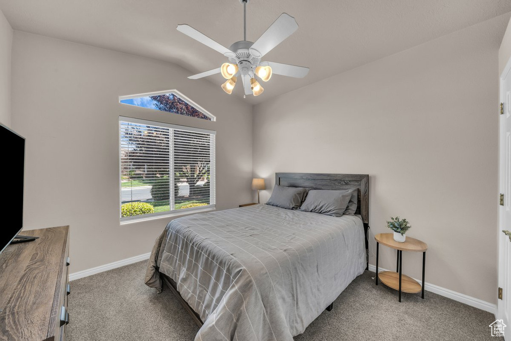 Bedroom with carpet floors, lofted ceiling, and ceiling fan