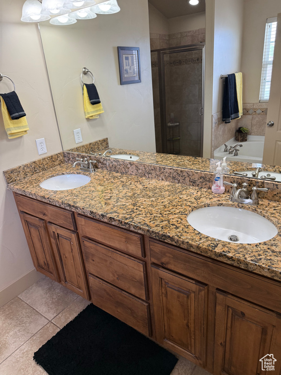 Full bath featuring a stall shower, double vanity, a garden tub, and tile patterned flooring