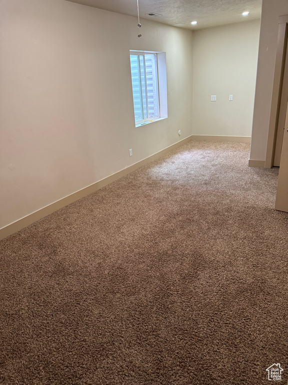Unfurnished room with carpet, recessed lighting, and a textured ceiling