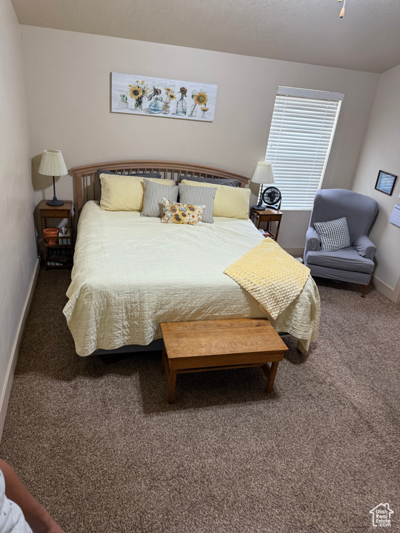 Carpeted bedroom featuring baseboards