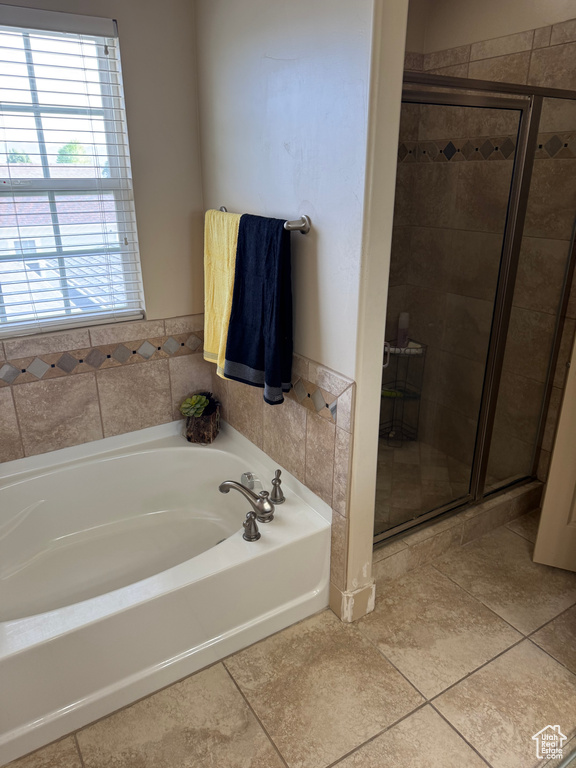Full bathroom with a bath, a shower stall, and tile patterned floors