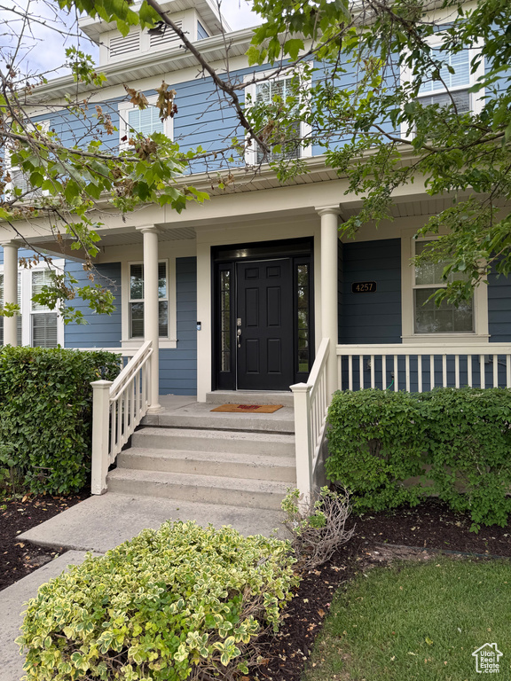 Property entrance with covered porch