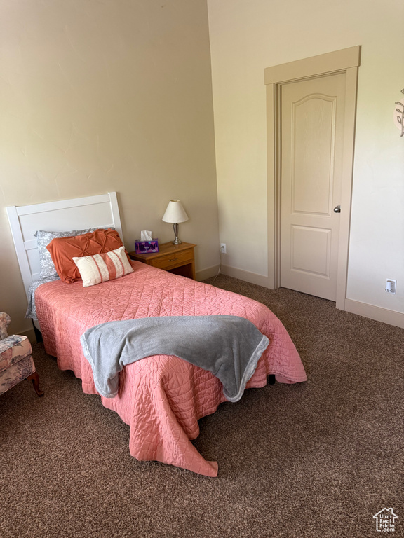 Bedroom featuring carpet flooring and baseboards