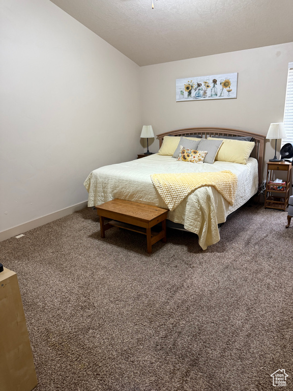 Bedroom featuring carpet floors and baseboards