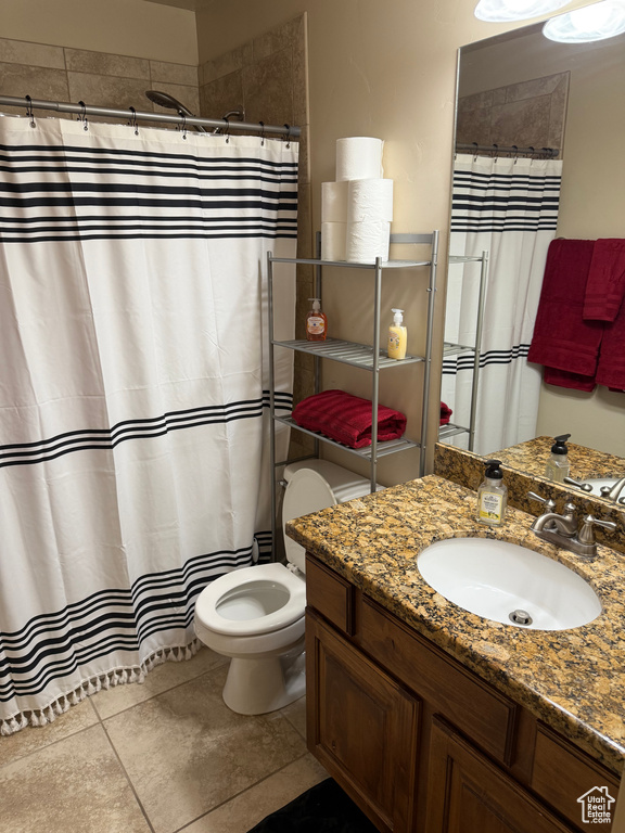 Full bathroom featuring vanity, a shower with curtain, and tile patterned flooring