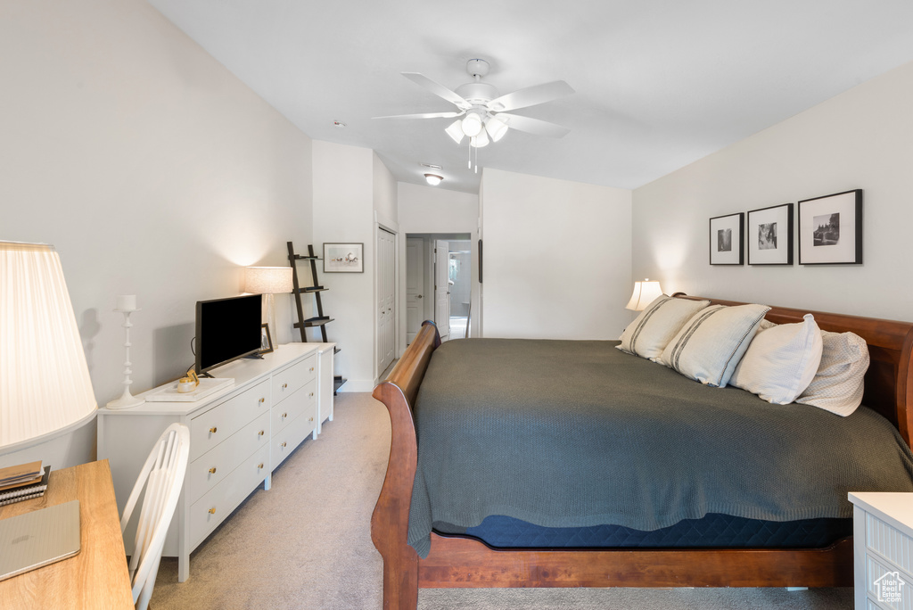 Bedroom with light carpet and ceiling fan