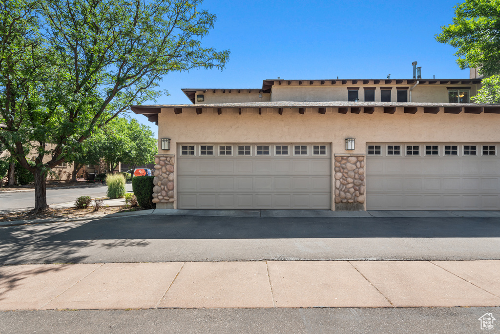 View of front of property featuring stucco siding and stone siding