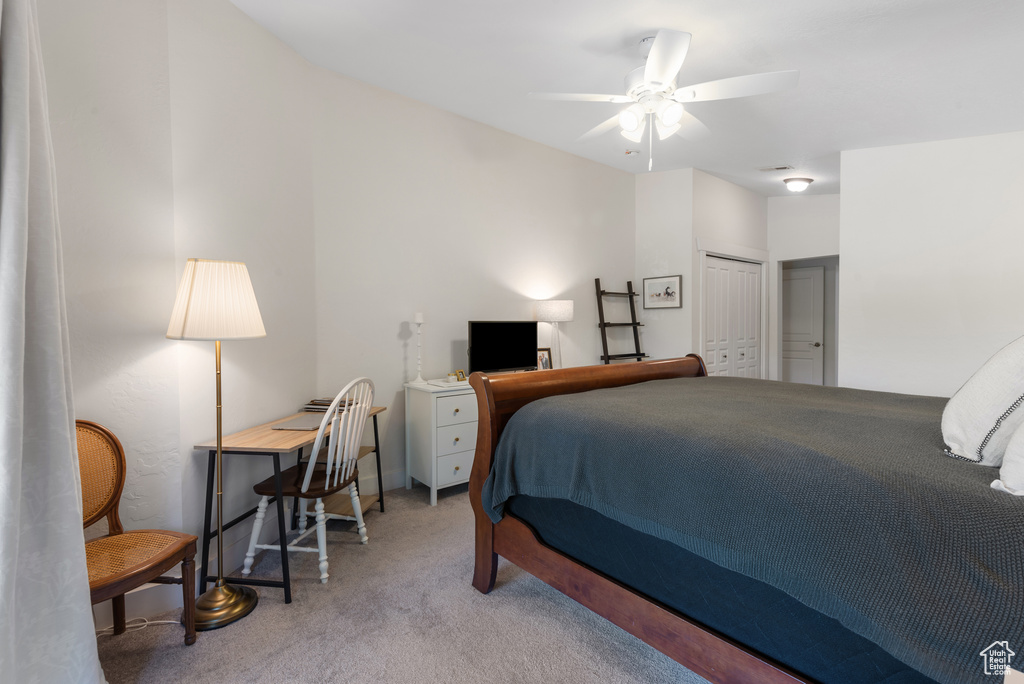 Carpeted bedroom with a closet and a ceiling fan