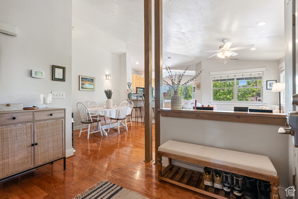 Interior space with ceiling fan, wood finished floors, recessed lighting, and a textured ceiling