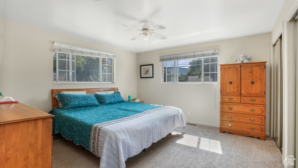 Bedroom featuring carpet floors, ceiling fan, and a closet