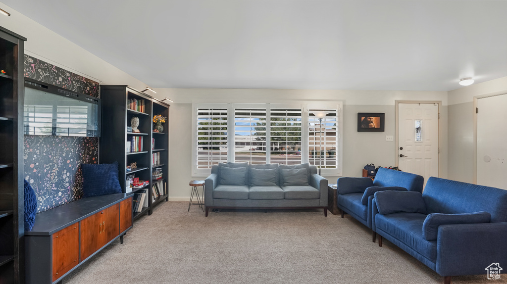 Living area featuring light colored carpet and healthy amount of natural light