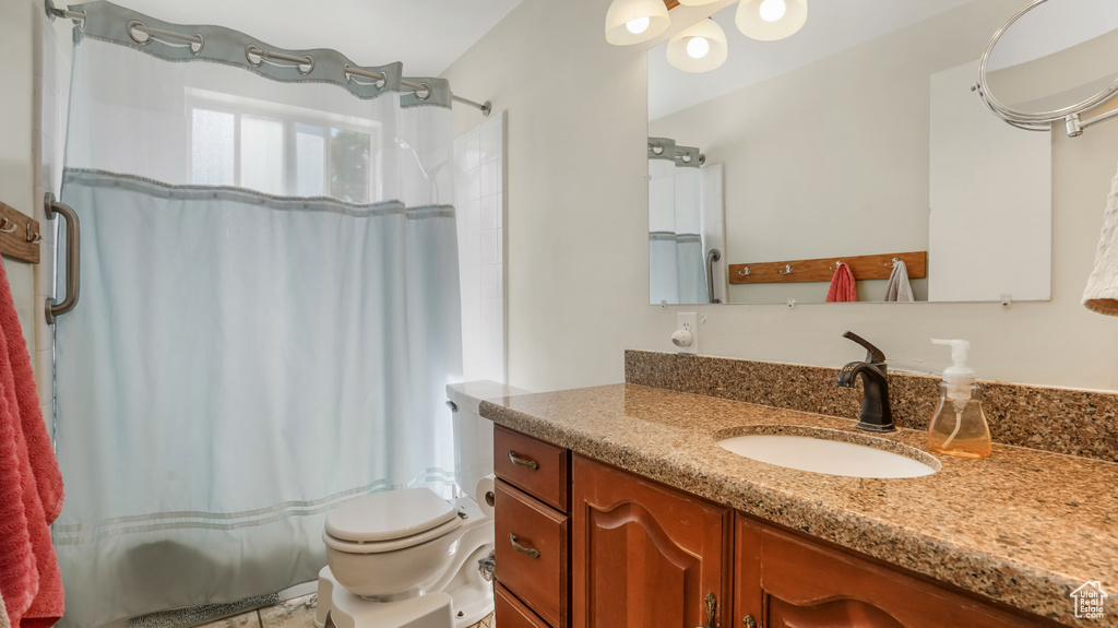 Bathroom with vanity and a shower with shower curtain
