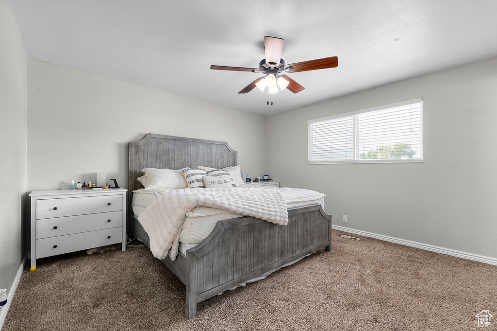 Bedroom with carpet floors and a ceiling fan