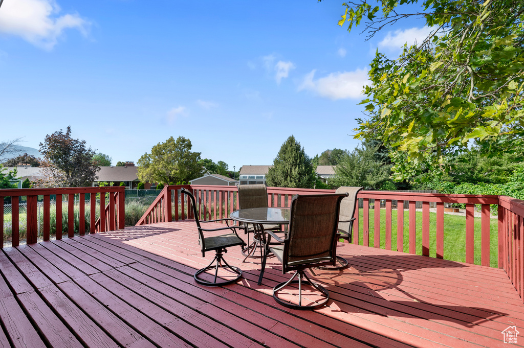Wooden terrace featuring outdoor dining area