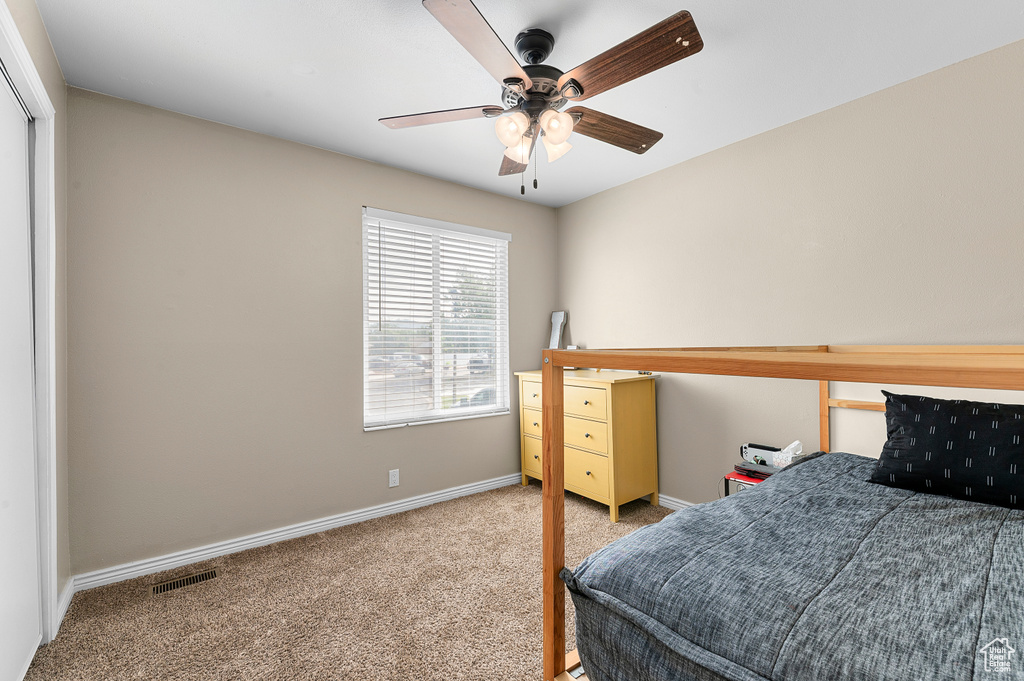 Bedroom featuring carpet and ceiling fan