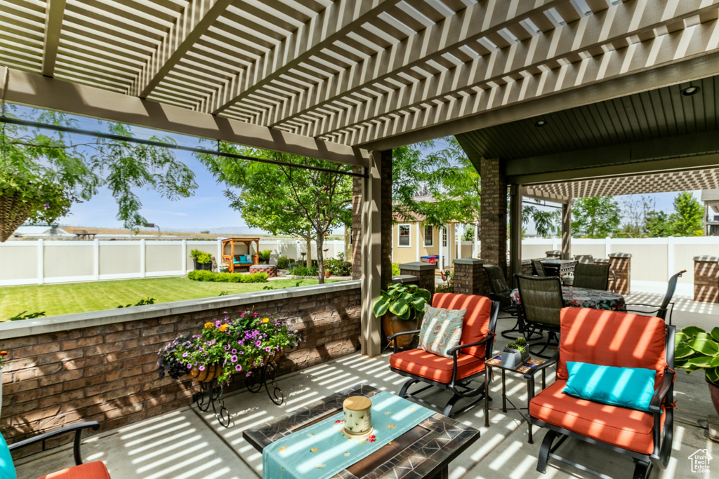 Fenced backyard featuring outdoor dining space, a patio area, and a pergola