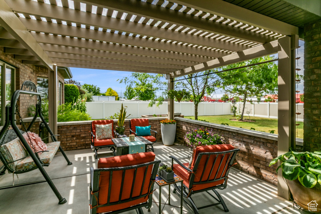 Fenced backyard featuring a patio, a pergola, and an outdoor hangout area