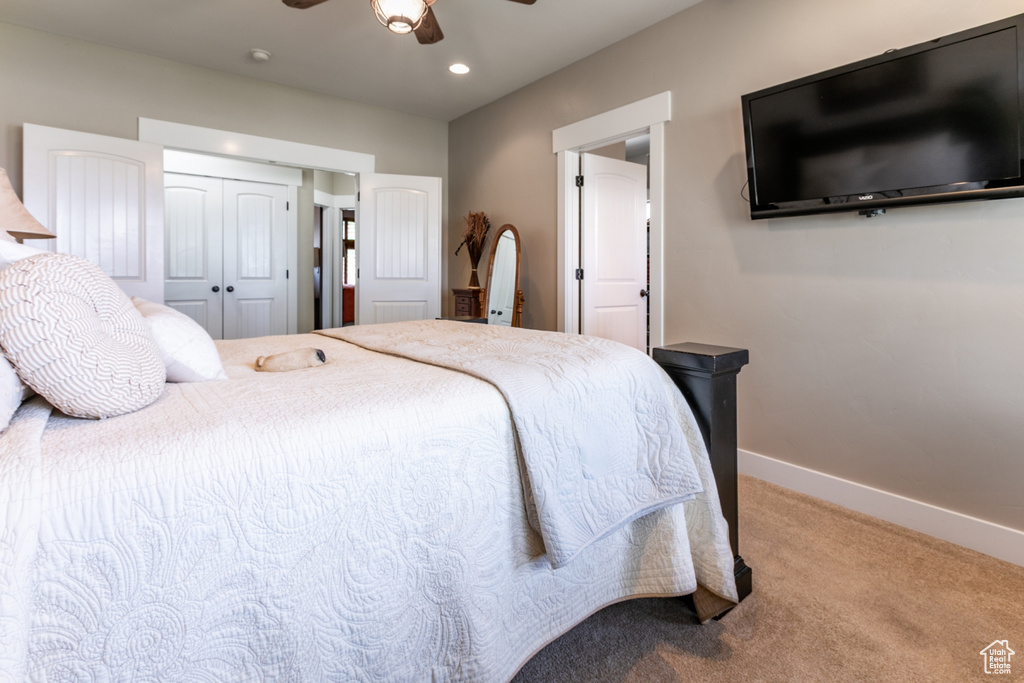Carpeted bedroom featuring recessed lighting, a ceiling fan, and a closet