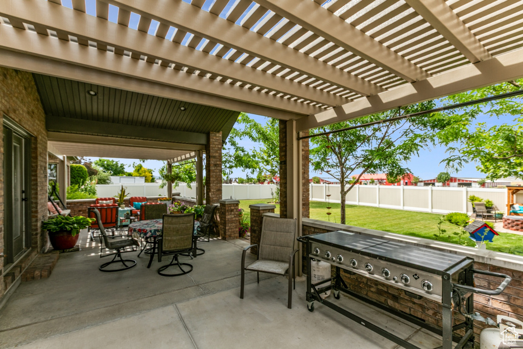 Fenced backyard featuring outdoor dining space, a patio, and a pergola