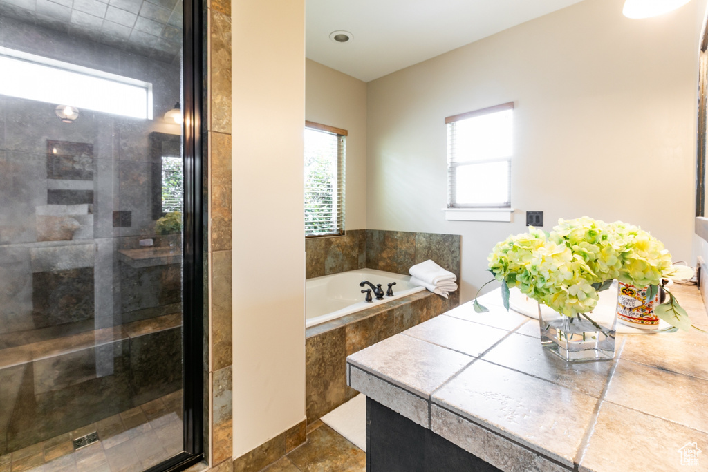Bathroom with a shower stall and a garden tub