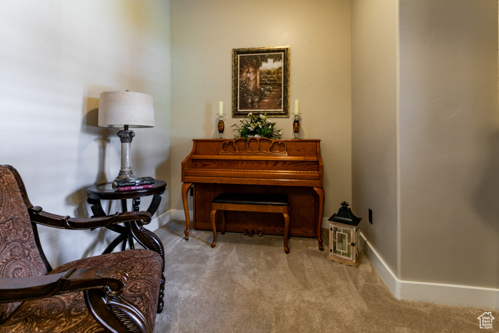 Living area featuring carpet floors and baseboards