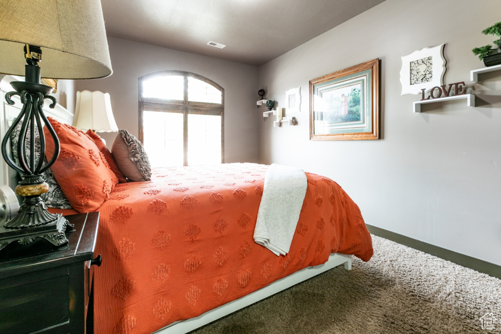 Bedroom with carpet flooring and baseboards