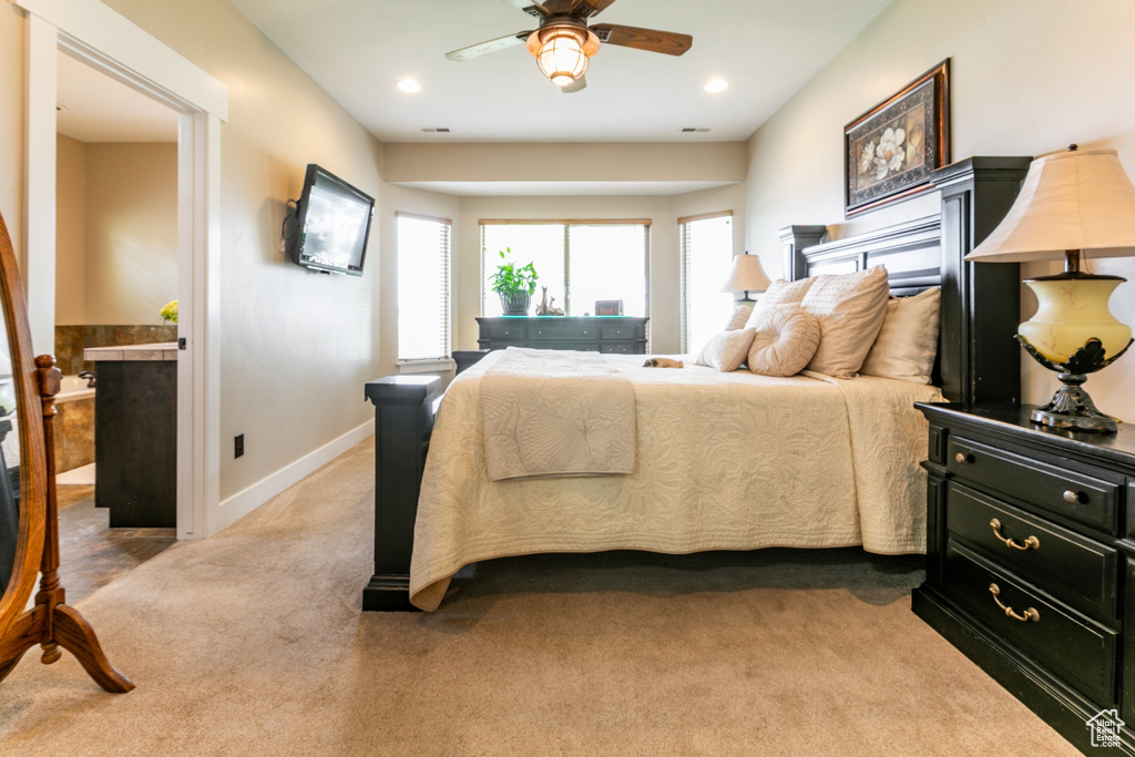 Carpeted bedroom featuring a ceiling fan and recessed lighting