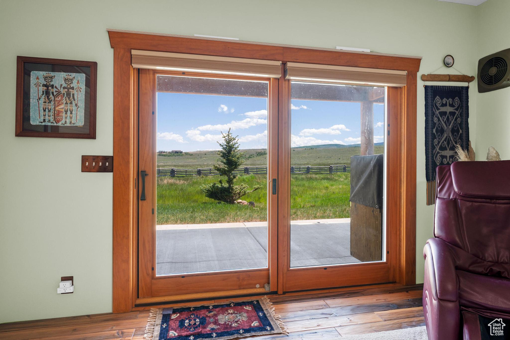Entryway featuring plenty of natural light, wood finished floors, and a rural view