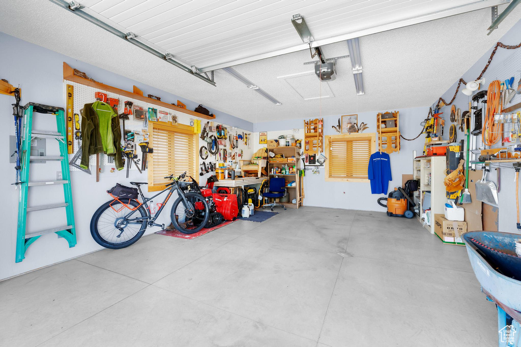 Garage with a workshop area and a garage door opener