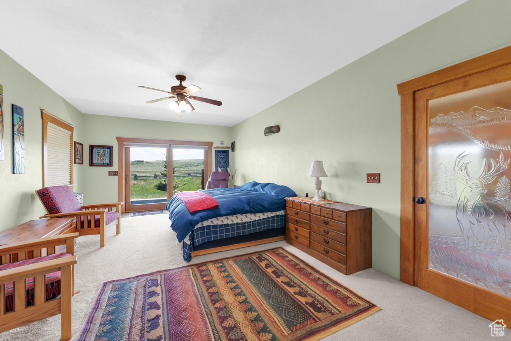 Bedroom with light colored carpet and ceiling fan