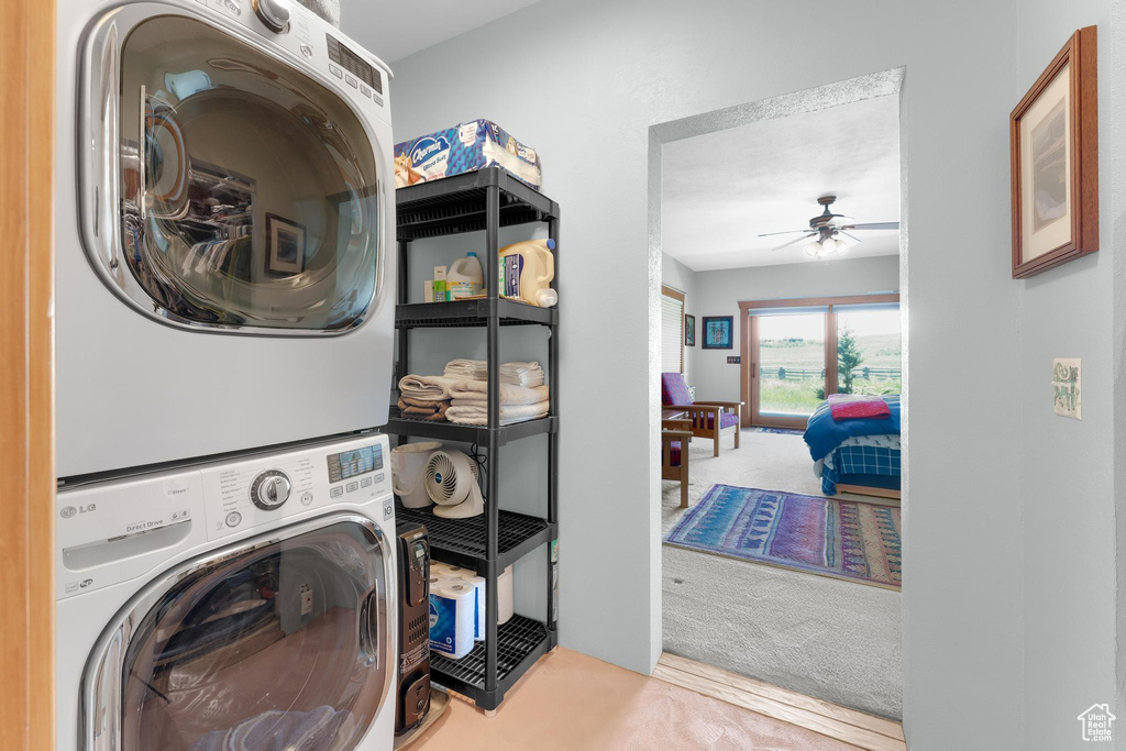 Washroom with stacked washing machine and dryer and ceiling fan